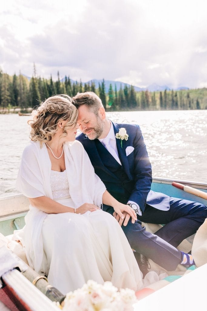 Just married couple in Jasper going  on a boat ride taking photos