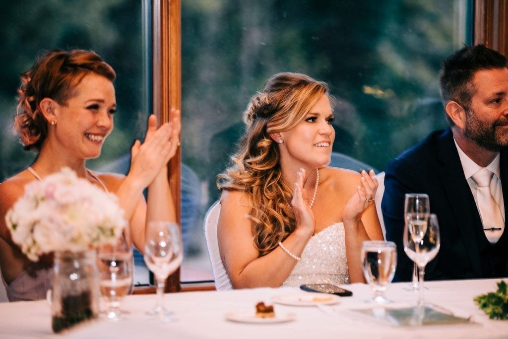 Happy bride clapping after her dad's speech at her wedding day in Jasper