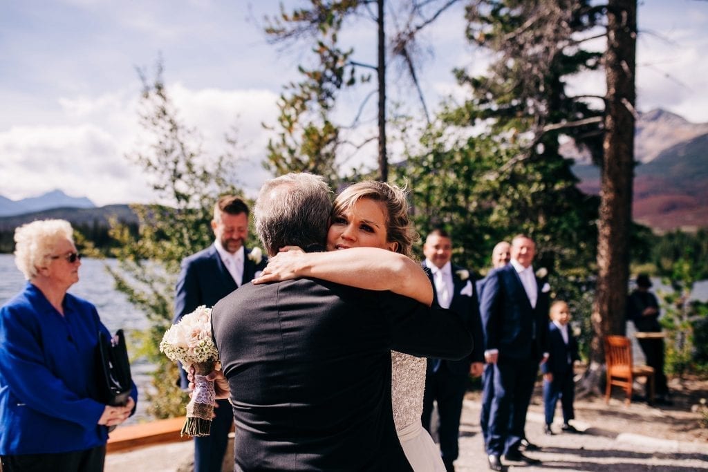 Bride hugging her dad as he guves her away to her future husband on Pyramid Lake