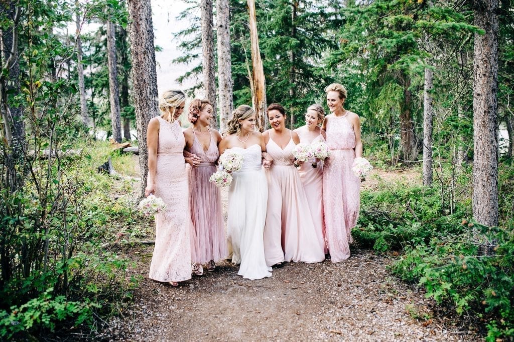 The bride and her girls in amazing all different pink gowns